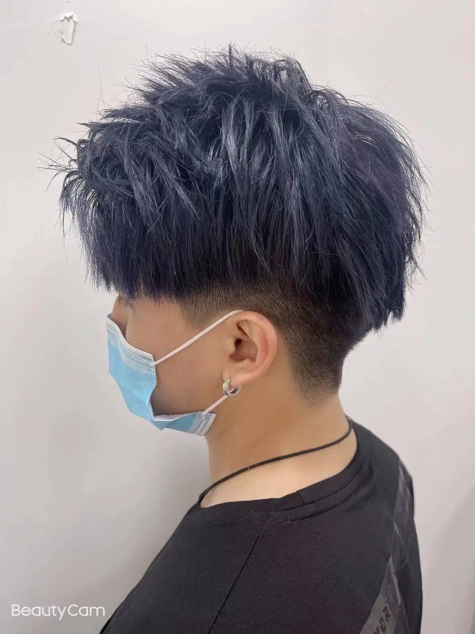 Textured haircut with faded sides and layered top hairstyle at Bonbon Blowout Bar+.